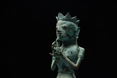 An fine Indonesian bronze sculpture of a naked man offering a sacrificial vase, Majapahit, East Java, 13/14th C.