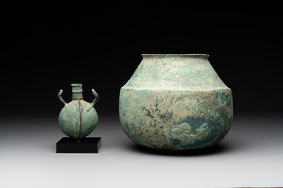 A bronze urn, a bronze canteen with relief design and a pair of bronze oil lamps, Roman Empire, 9th C. B.C/5th C.