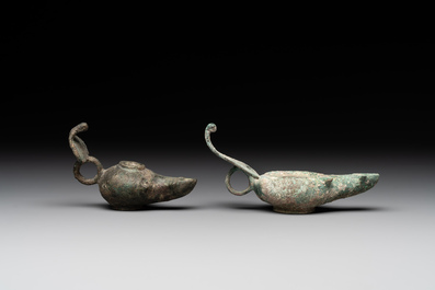 A bronze urn, a bronze canteen with relief design and a pair of bronze oil lamps, Roman Empire, 9th C. B.C/5th C.