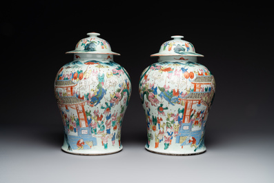 A pair of Chinese famille rose 'hundred boys' vases and covers on wooden stands, 19th C.