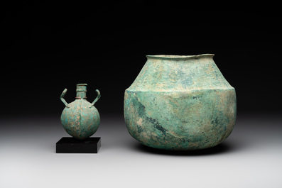 A bronze urn, a bronze canteen with relief design and a pair of bronze oil lamps, Roman Empire, 9th C. B.C/5th C.