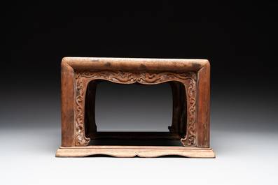 A Chinese rectangular huanghuali wooden stool with 'chilong' design, 17/18th C.