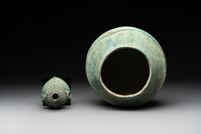 A bronze urn, a bronze canteen with relief design and a pair of bronze oil lamps, Roman Empire, 9th C. B.C/5th C.