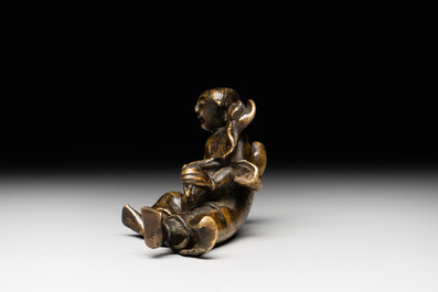 A Chinese bronze paperweight in the form of 'Shi De 拾得' on wooden stand, 16th C.