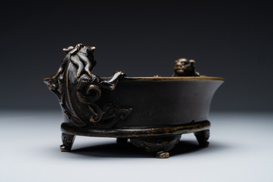 A rare Chinese bronze narcissus basin-shaped censer with dragon handles, Xuande mark, 17th C.