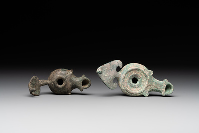 A bronze urn, a bronze canteen with relief design and a pair of bronze oil lamps, Roman Empire, 9th C. B.C/5th C.