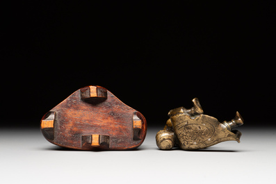 A Chinese bronze paperweight in the form of 'Shi De 拾得' on wooden stand, 16th C.