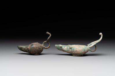 A bronze urn, a bronze canteen with relief design and a pair of bronze oil lamps, Roman Empire, 9th C. B.C/5th C.