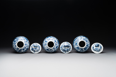 A Chinese blue and white garniture of five vases with lotus scrolls, 19th C.