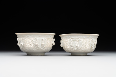 A pair of rare Chinese reticulated white-glazed biscuit 'Eight Immortals and Shoulao' bowls, Wanli