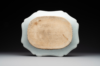 A Chinese famille rose 'He Xiangu' charger with a blue and white border, Qianlong