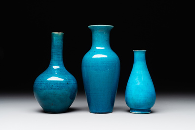 Three Chinese monochrome turquoise-glazed vases with two wooden stands, Kangxi and later