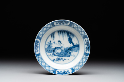 A Chinese blue and white 'erotic' cup and saucer, Kangxi