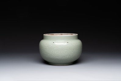 A Chinese monochrome celadon-glazed jar with anhua chilong and floral design, Kangxi