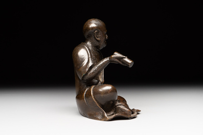A small Chinese bronze figure of a Luohan, Ming