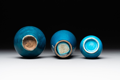 Three Chinese monochrome turquoise-glazed vases with two wooden stands, Kangxi and later