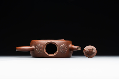 A Chinese circle-shaped Yixing stoneware 'kylin' teapot with relief design, Kangxi