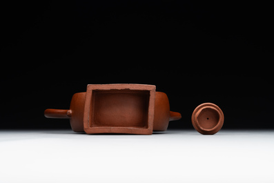 A Chinese circle-shaped Yixing stoneware 'kylin' teapot with relief design, Kangxi