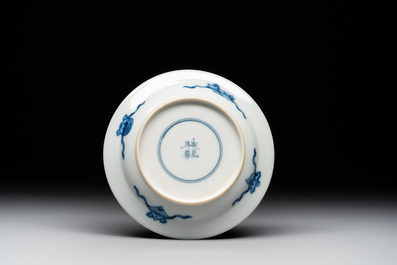 A Chinese blue and white 'erotic' cup and saucer, Kangxi