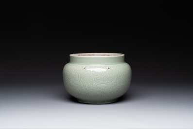 A Chinese monochrome celadon-glazed jar with anhua chilong and floral design, Kangxi