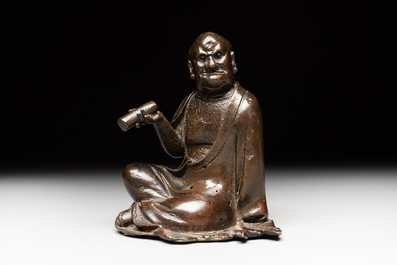 A small Chinese bronze figure of a Luohan, Ming
