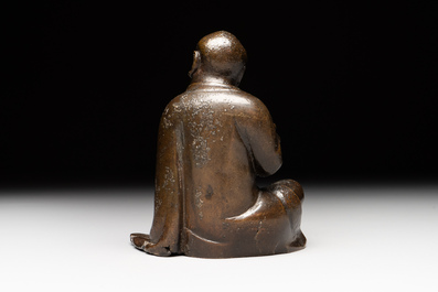 A small Chinese bronze figure of a Luohan, Ming