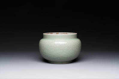 A Chinese monochrome celadon-glazed jar with anhua chilong and floral design, Kangxi