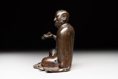 A small Chinese bronze figure of a Luohan, Ming