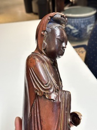 A Chinese partly gilt and lacquered wooden sculpture of Guanyin, Ming