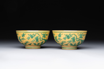 A pair of Chinese yellow-ground 'peach and bird' bowls, Qianlong mark and probably of the period