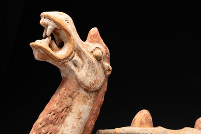 A pair of Chinese polychrome-painted terracotta camels with saddles, Tang