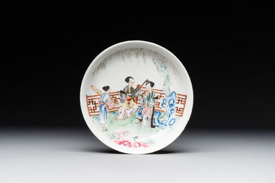 A Chinese famille rose cup and saucer with music making ladies, Yongzheng/Qianlong