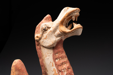 A pair of Chinese polychrome-painted terracotta camels with saddles, Tang