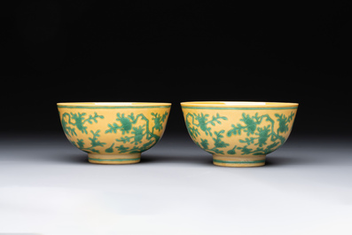 A pair of Chinese yellow-ground 'peach and bird' bowls, Qianlong mark and probably of the period
