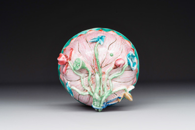 A Chinese famille rose relief-decorated 'lotus' cup and saucer, Yongzheng