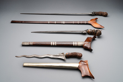 A collection of six krises with carved handles, four with scabbard, Indonesia, 19th C.