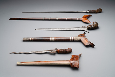A collection of six krises with carved handles, four with scabbard, Indonesia, 19th C.