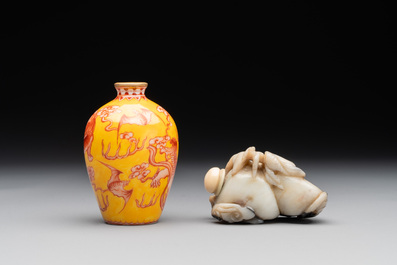 A Chinese jade snuff bottle and a yellow-ground iron-red snuff bottle, Daoguang mark, 19th C.