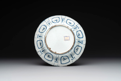 A Chinese blue and white kraak porcelain dish with flowers in a jardiniere, Wanli