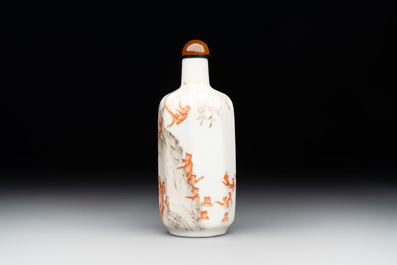 A Chinese iron-red and grisaille snuff bottle with monkeys at the Shuilian cave, 19th C.