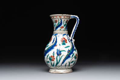 A polychrome and gilt Iznik ewer with tulips, carnation flowers and saz leaves, Turkey, ca. 1600