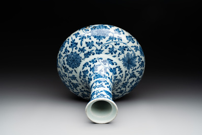 A Chinese blue and white 'lotus scroll' bottle vase, 18/19th C.