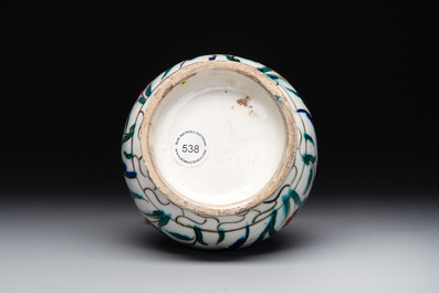 A polychrome and gilt Iznik ewer with tulips, carnation flowers and saz leaves, Turkey, ca. 1600
