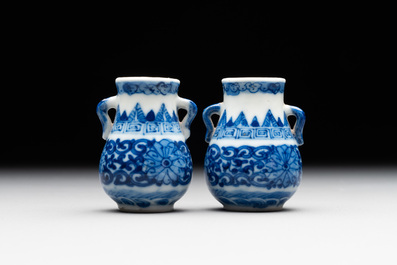 A pair of Chinese blue and white miniature 'hu' vases on wooden stands, Kangxi mark, 19th C.