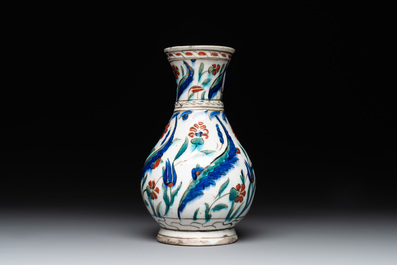 A polychrome and gilt Iznik ewer with tulips, carnation flowers and saz leaves, Turkey, ca. 1600