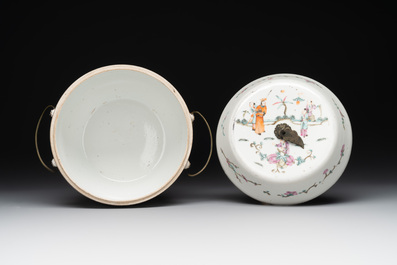 A pair of Chinese famille rose jars and covers with figures in a garden, Tongzhi mark and of the period