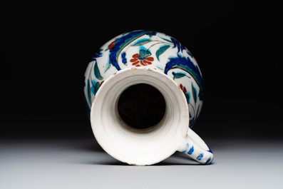 A polychrome and gilt Iznik ewer with tulips, carnation flowers and saz leaves, Turkey, ca. 1600