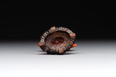 A Chinese carved red coral ewer and cover on wooden stand, 19th C.
