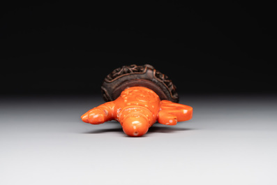 A Chinese carved red coral ewer and cover on wooden stand, 19th C.