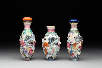Six Chinese moulded famille rose snuff bottles, Qianlong mark, 19th C.